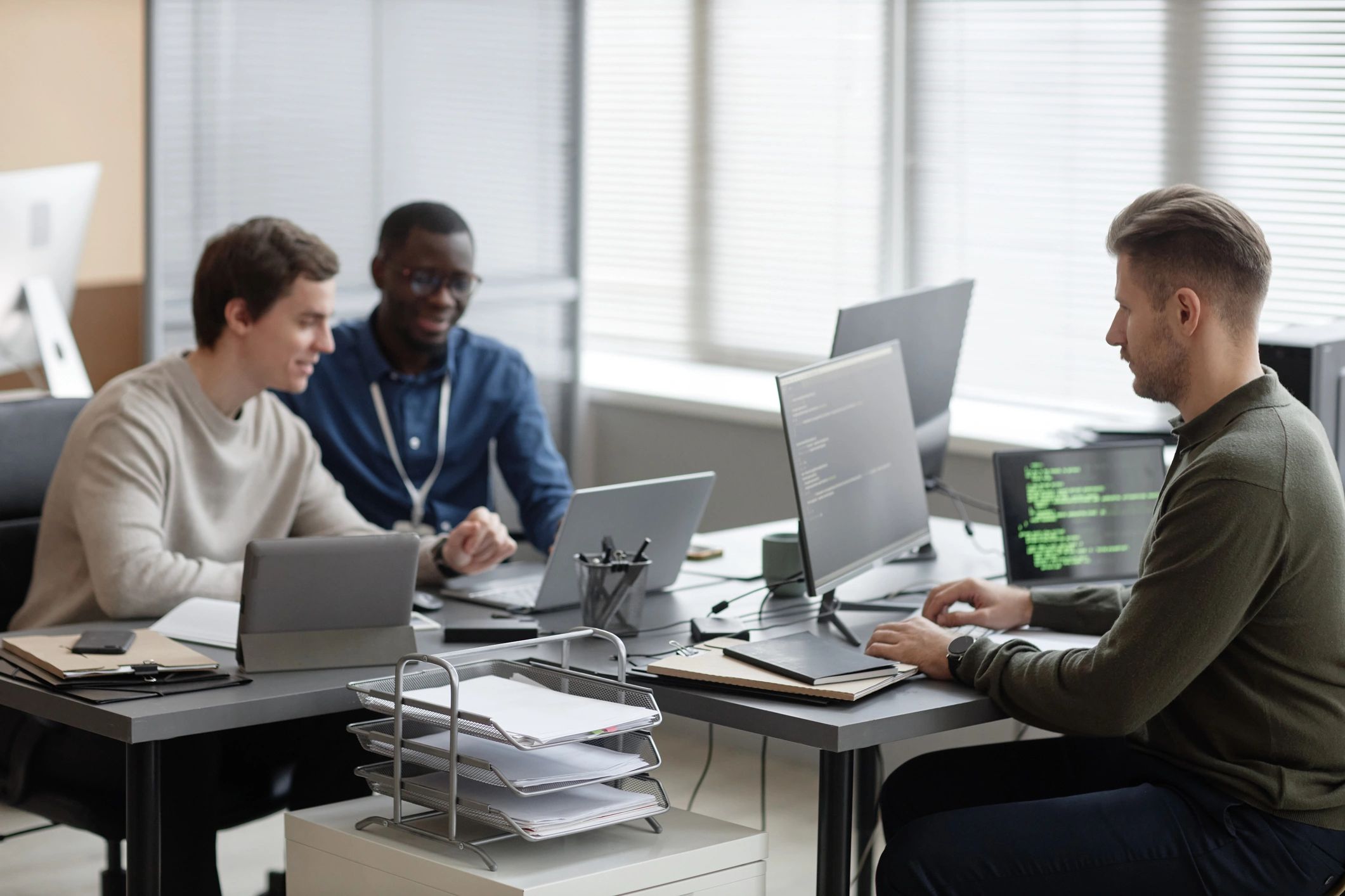 IT team working on cybersecurity systems in a modern office