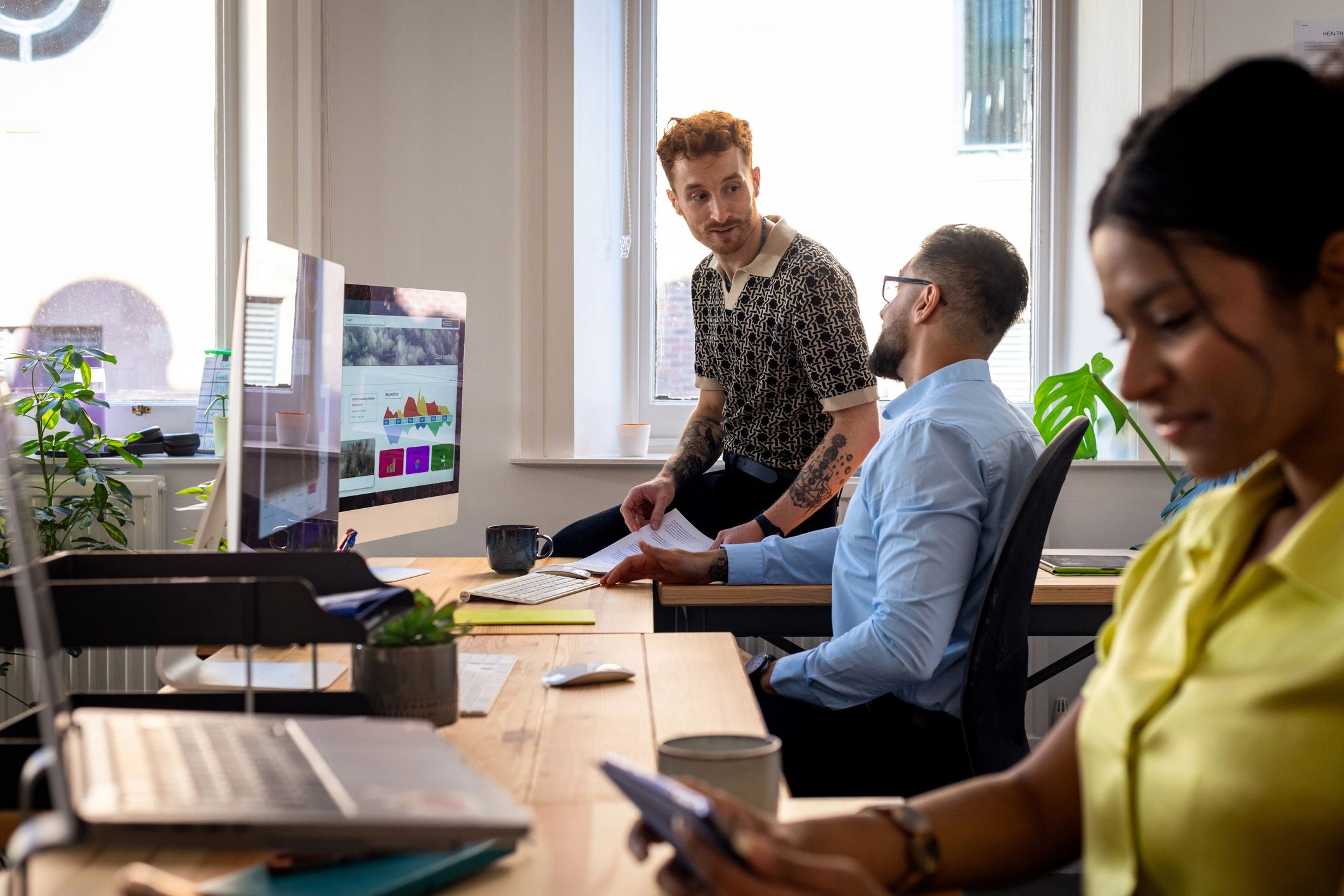 Small business IT support team working together in an office